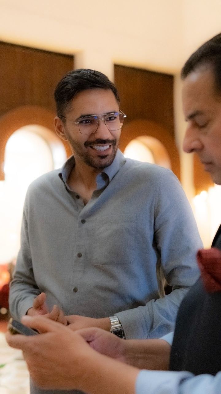 Faaiz smiling at an evening event