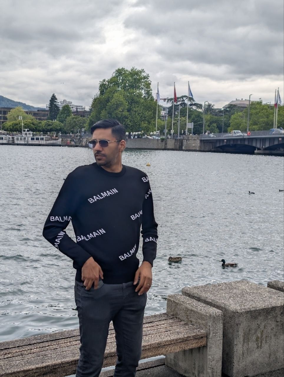 Faaiz by a lake under a grey sky in Zurich
